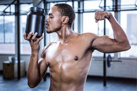 power of black - Fit shirtless man kissing protein powder Stock Photo - Premium Royalty-Free, Code: 6109-08398128