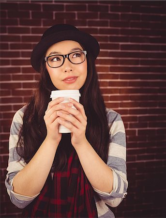 Attractive hipster holding take-away cup Fotografie stock - Premium Royalty-Free, Codice: 6109-08398200