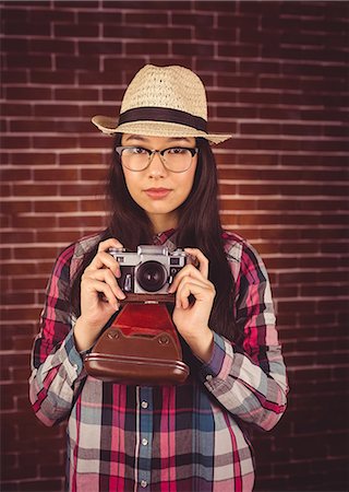 snapping fingers - Attractive hipster holding a camera Stock Photo - Premium Royalty-Free, Code: 6109-08398229