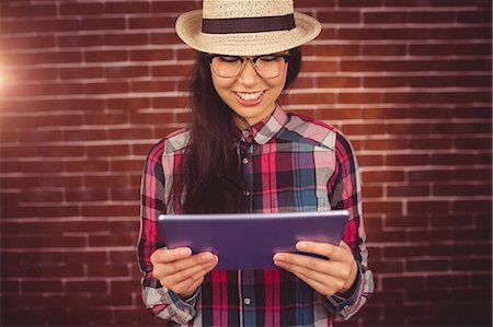 simsearch:6109-08398339,k - Attractive hipster holding her tablet Stock Photo - Premium Royalty-Free, Code: 6109-08398230