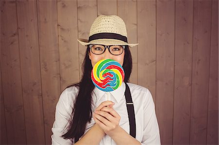 simsearch:6109-08690486,k - Pretty hipster with hat and lollipop Foto de stock - Sin royalties Premium, Código: 6109-08398324