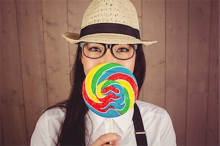 simsearch:6109-08398339,k - Pretty hipster with hat and lollipop Stock Photo - Premium Royalty-Free, Code: 6109-08398325