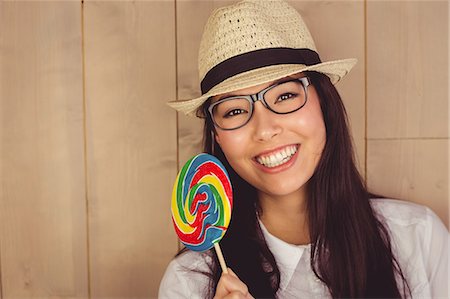 simsearch:6109-08398339,k - Pretty hipster with hat and lollipop Stock Photo - Premium Royalty-Free, Code: 6109-08398329