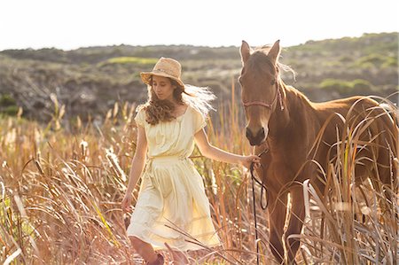 simsearch:6109-08398485,k - Young happy woman walking with her horse Foto de stock - Sin royalties Premium, Código: 6109-08398440