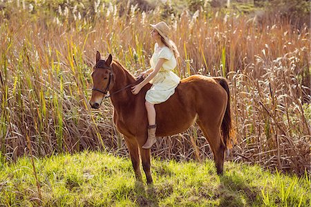 simsearch:6109-08398485,k - Young woman riding her horse Foto de stock - Sin royalties Premium, Código: 6109-08398449