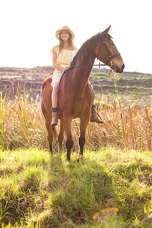 simsearch:6109-08398485,k - Young happy woman riding her horse Foto de stock - Sin royalties Premium, Código: 6109-08398456