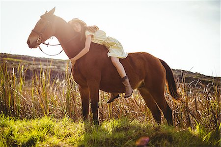 simsearch:6109-08398485,k - Young happy woman riding her horse Foto de stock - Sin royalties Premium, Código: 6109-08398460