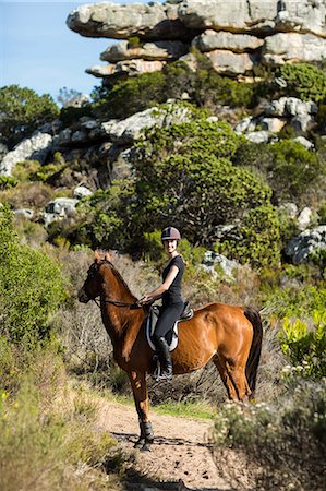 simsearch:6109-08398485,k - Young woman riding her horse Foto de stock - Sin royalties Premium, Código: 6109-08398473