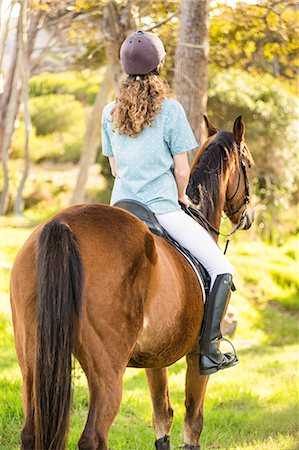 simsearch:6109-08398485,k - Young woman riding her horse Foto de stock - Sin royalties Premium, Código: 6109-08398497