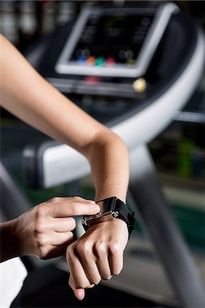 physically fit - Woman scrolling smart watch Stock Photo - Premium Royalty-Free, Code: 6109-08398593