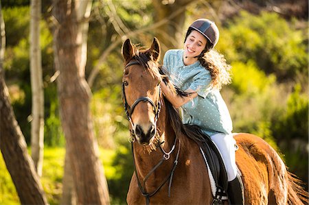 simsearch:6109-08399507,k - Young woman riding her horse Foto de stock - Sin royalties Premium, Código: 6109-08398500