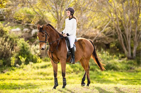 simsearch:6109-08398485,k - Young woman riding her horse Foto de stock - Sin royalties Premium, Código: 6109-08398507