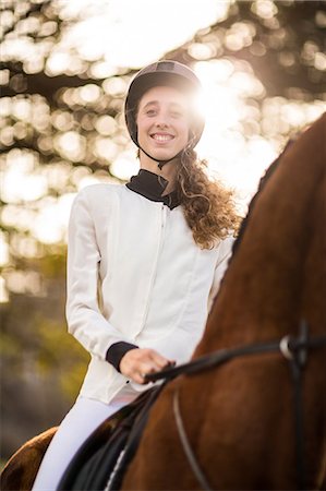 simsearch:6109-08398485,k - Young woman riding her horse Foto de stock - Sin royalties Premium, Código: 6109-08398508