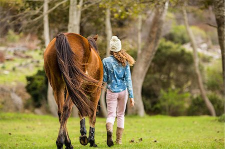 simsearch:6109-08398485,k - Young woman walking with her horse Foto de stock - Sin royalties Premium, Código: 6109-08398516