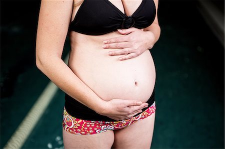 sport studio - Pregnant woman touching her belly Stock Photo - Premium Royalty-Free, Code: 6109-08398719