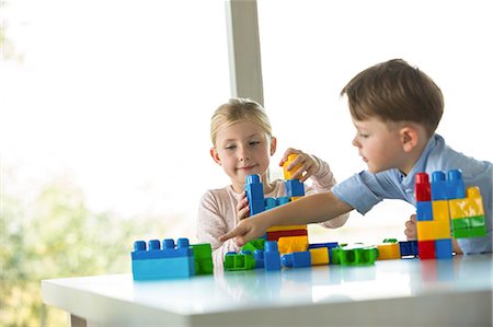 Cute siblings playing building blocks Stock Photo - Premium Royalty-Free, Code: 6109-08398870