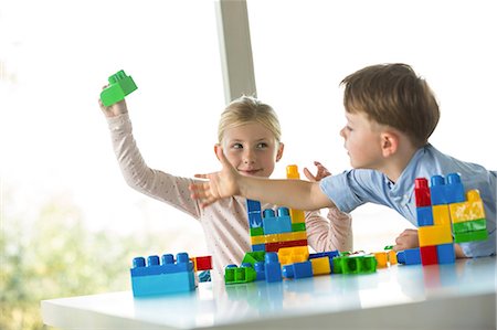 Cute siblings playing building blocks Stock Photo - Premium Royalty-Free, Code: 6109-08398871