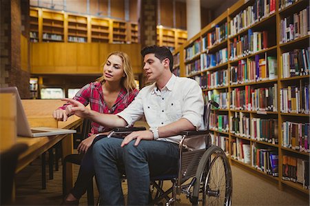 paraplegic women in wheelchairs - Student in wheelchair working with a classmate Stock Photo - Premium Royalty-Free, Code: 6109-08398922