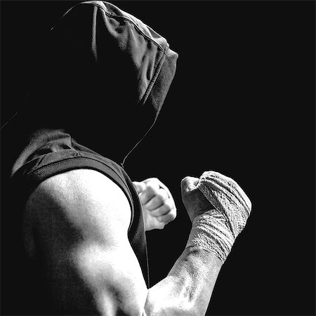 Composite image of muscular man in blue hood with fighting stance Foto de stock - Sin royalties Premium, Código: 6109-08399464