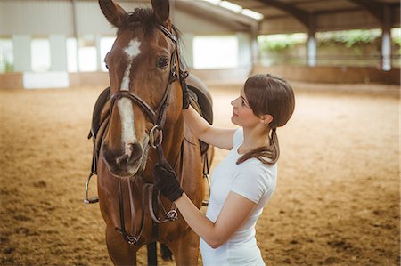 simsearch:6109-08399536,k - Female rider leading her horse Stock Photo - Premium Royalty-Free, Code: 6109-08399471
