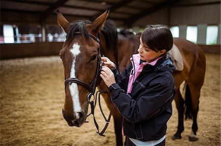 simsearch:6109-08399497,k - Female rider leading her horse Foto de stock - Sin royalties Premium, Código: 6109-08399476