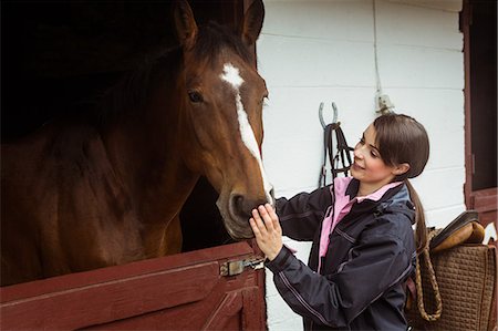 simsearch:6109-08399536,k - Pretty woman taking care of her horse Stock Photo - Premium Royalty-Free, Code: 6109-08399499