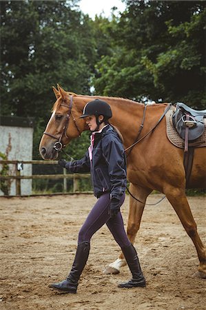 simsearch:6109-08399536,k - Female rider leading her horse Stock Photo - Premium Royalty-Free, Code: 6109-08399521