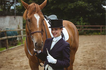 simsearch:400-06517682,k - Female jockey leading her horse Stock Photo - Premium Royalty-Free, Code: 6109-08399526