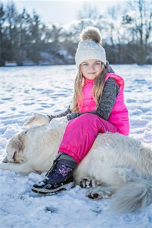 sleep fun - Little girl sitting on a dog on a beautiful snowy day Stock Photo - Premium Royalty-Free, Code: 6109-08481770