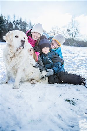 simsearch:6109-08435908,k - Family posing with a dog on a beautiful snowy day Stock Photo - Premium Royalty-Free, Code: 6109-08481771