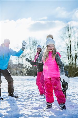 simsearch:6109-08945297,k - Family playing snowball fight on a beautiful snowy day Stock Photo - Premium Royalty-Free, Code: 6109-08481781