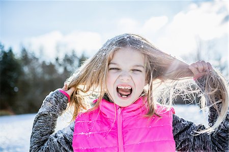 Little girl screaming while holding her hair on a beautiful snowy day Stock Photo - Premium Royalty-Free, Code: 6109-08481790