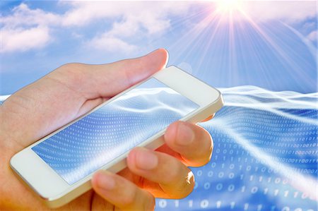 sun stream - Hand holding smartphone on digital background Foto de stock - Sin royalties Premium, Código: 6109-08481855