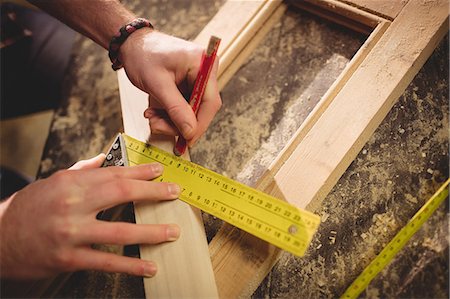 Carpenter working on his craft in a dusty workshop Stock Photo - Premium Royalty-Free, Code: 6109-08481884