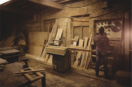 simsearch:6109-08481994,k - Carpenter working on his craft in a dusty workshop Stock Photo - Premium Royalty-Free, Code: 6109-08481899