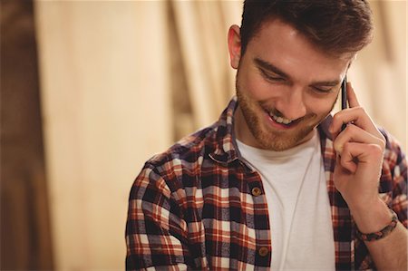 simsearch:6109-08481919,k - Happy carpenter on the phone in a dusty workshop Foto de stock - Sin royalties Premium, Código: 6109-08481905