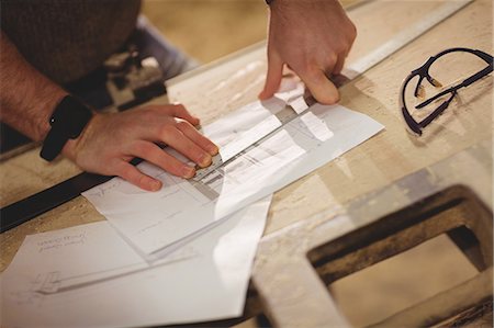 simsearch:6109-08481913,k - Carpenter working on his craft in a dusty workshop Foto de stock - Sin royalties Premium, Código: 6109-08481916