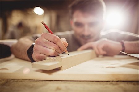 simsearch:6109-08764384,k - Happy carpenter working on his craft in a dusty workshop Foto de stock - Sin royalties Premium, Código: 6109-08481920