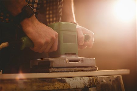 simsearch:6109-08481907,k - Carpenter working on his craft in a dusty workshop Stockbilder - Premium RF Lizenzfrei, Bildnummer: 6109-08481938