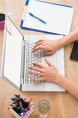 simsearch:6109-08581414,k - Casual businesswoman using laptop in the office Stock Photo - Premium Royalty-Free, Code: 6109-08488642