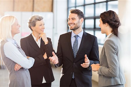 simsearch:6109-08488759,k - Business team standing and speaking at the office Stock Photo - Premium Royalty-Free, Code: 6109-08488750