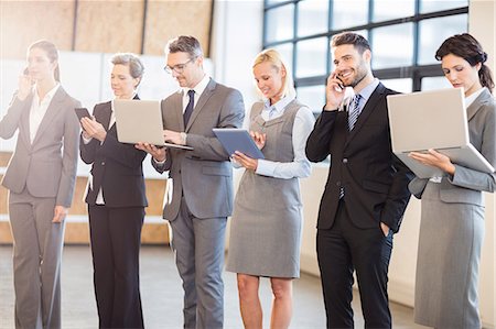 Business team using their media devices at the office Photographie de stock - Premium Libres de Droits, Code: 6109-08488759