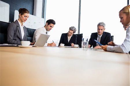 simsearch:6109-06781524,k - Business team having a meeting at the office Stock Photo - Premium Royalty-Free, Code: 6109-08488773