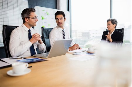 simsearch:6109-08488759,k - Business team having a meeting at the office Stock Photo - Premium Royalty-Free, Code: 6109-08488770