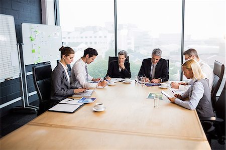 simsearch:6109-08488759,k - Business team having a meeting at the office Stock Photo - Premium Royalty-Free, Code: 6109-08488772