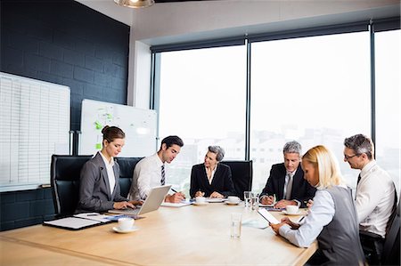 simsearch:6109-08488781,k - Business team having a meeting at the office Stock Photo - Premium Royalty-Free, Code: 6109-08488774