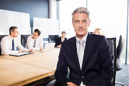 simsearch:6109-06781524,k - Businessman smiling at the camera during meeting at the office Stock Photo - Premium Royalty-Free, Code: 6109-08488791