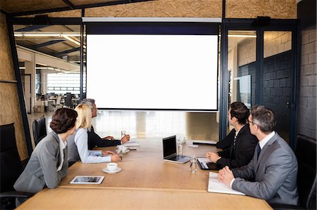 simsearch:6109-08488781,k - Business team using video chat during meeting at the office Stock Photo - Premium Royalty-Free, Code: 6109-08488794