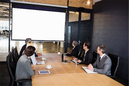 Business team using video chat during meeting at the office Photographie de stock - Premium Libres de Droits, Code: 6109-08488796