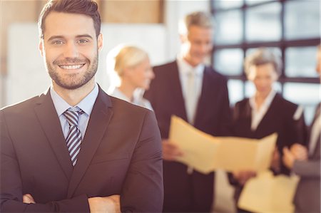 simsearch:6109-08394968,k - Businessman smiling at the camera at the office Stock Photo - Premium Royalty-Free, Code: 6109-08488723